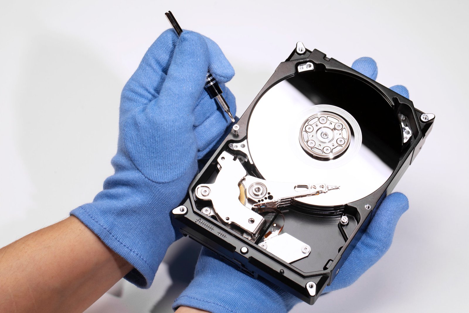 high-angle-hands-repairing-hard-drive